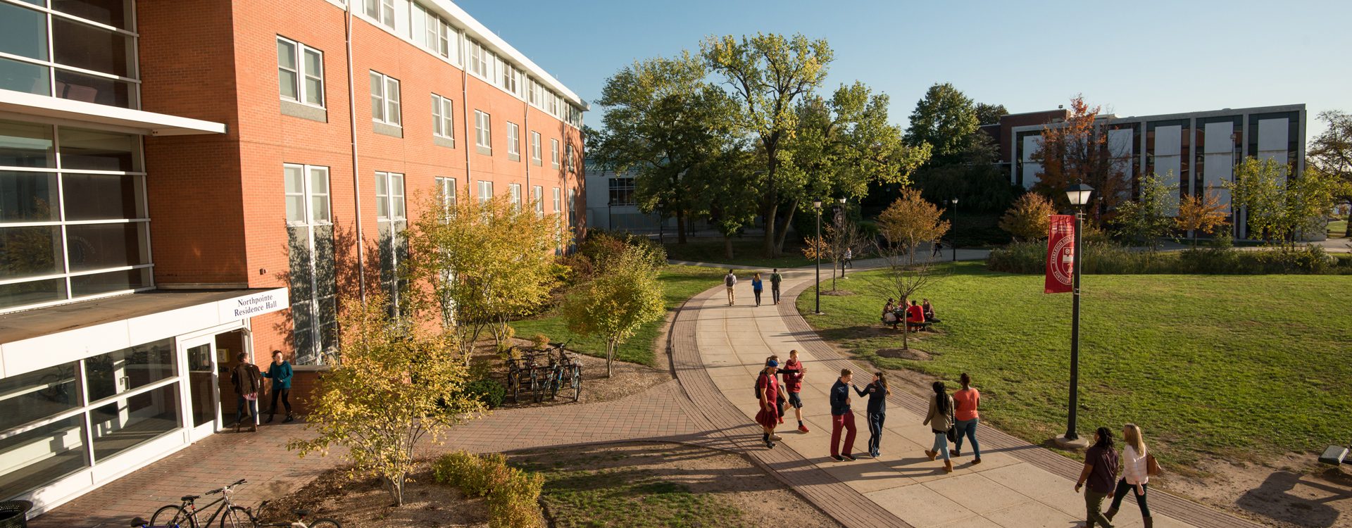 Northpointe Residence Hall path with students walking on the Metropolitan Campus.