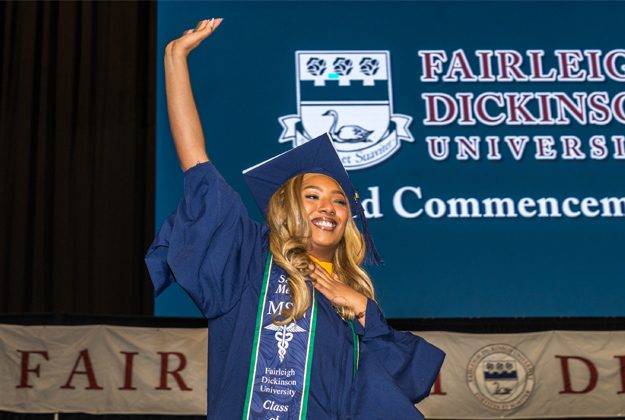 student_waving_at_commencement